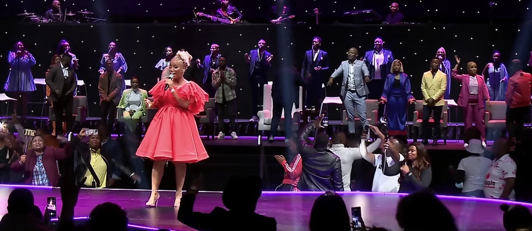 Phindi P performing on stage in front of a large audience