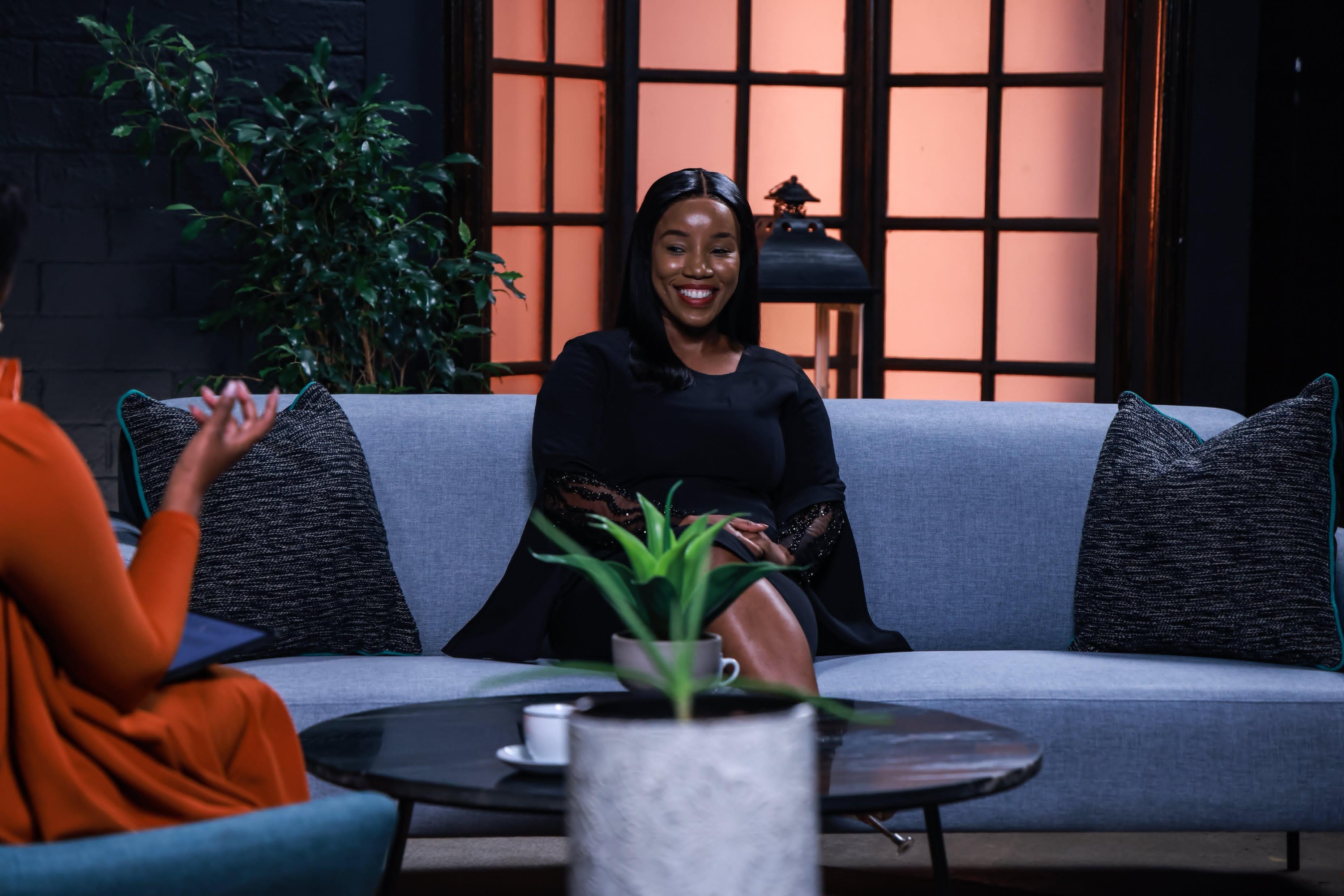 Phindi P smiling during a television interview